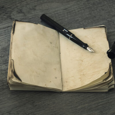 Fountain pen on aged notebook symbolizing the careful documentation and nuanced differences between common law and civil law systems in legal translation.